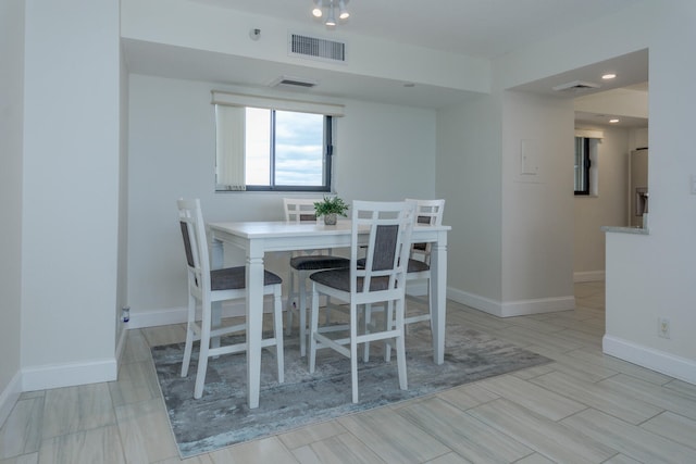 dining space with light hardwood / wood-style flooring