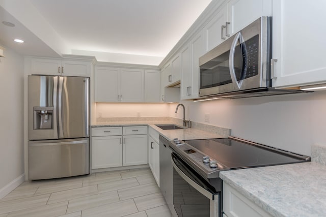 kitchen with white cabinets, stainless steel appliances, and sink