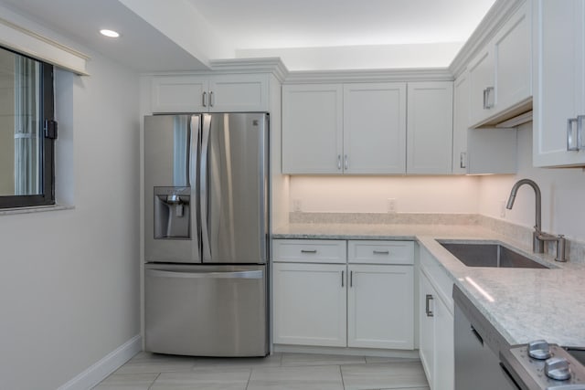 kitchen with white cabinets, stainless steel appliances, and sink