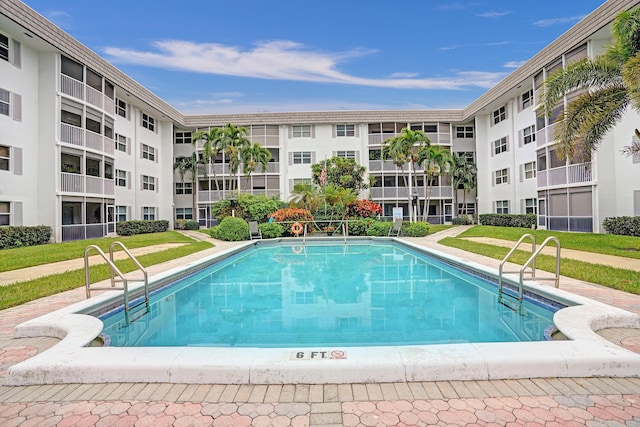 view of pool featuring a yard