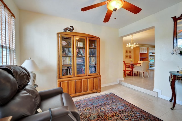 living room with light tile patterned floors and ceiling fan with notable chandelier