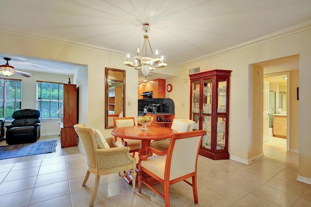 dining area featuring light tile patterned floors, ceiling fan with notable chandelier, and crown molding