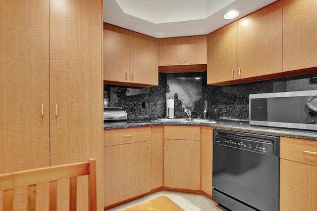 kitchen featuring sink, black dishwasher, tasteful backsplash, dark stone countertops, and light tile patterned floors