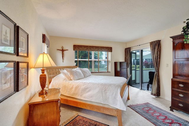 bedroom featuring access to outside, multiple windows, and light colored carpet