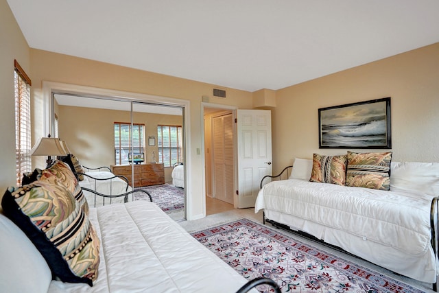 bedroom featuring carpet and a closet