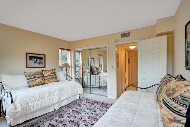 carpeted bedroom with a closet