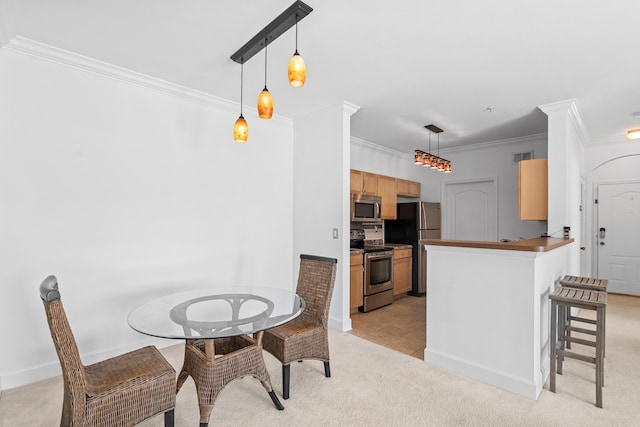 dining room featuring crown molding and light carpet