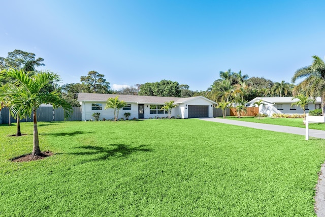 single story home with a garage and a front lawn