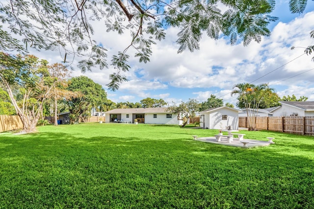 view of yard with a storage shed and a patio area