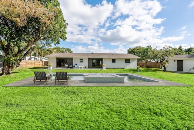 back of house featuring a fenced in pool, a lawn, and a patio