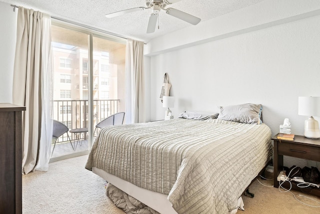 bedroom with access to outside, ceiling fan, carpet, and a textured ceiling