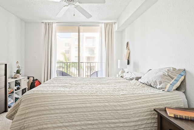 bedroom featuring access to exterior, a textured ceiling, ceiling fan, and carpet flooring