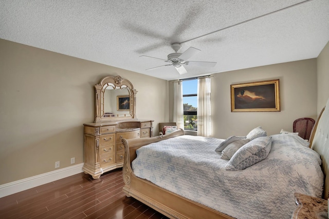 bedroom featuring ceiling fan, dark hardwood / wood-style flooring, and a textured ceiling