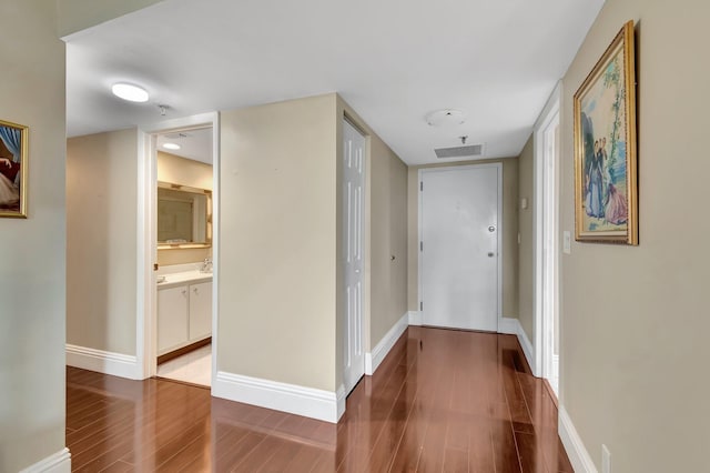 corridor featuring hardwood / wood-style floors and sink