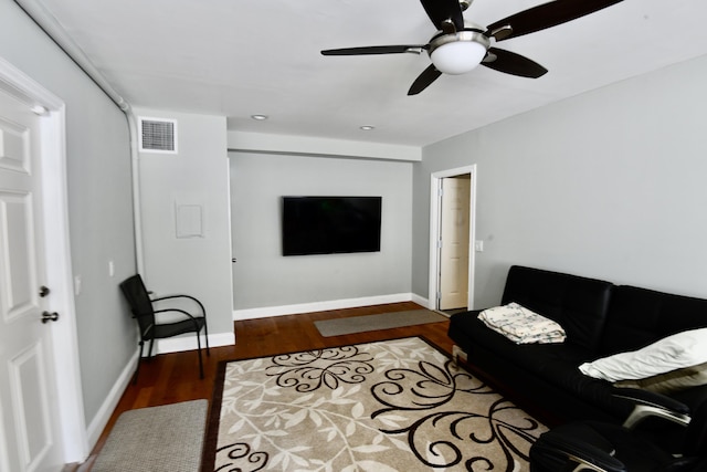 living room featuring hardwood / wood-style floors and ceiling fan