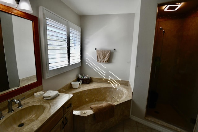 bathroom with a tub to relax in, tile patterned flooring, and vanity