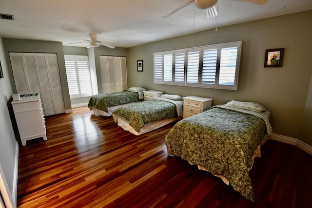 bedroom featuring ceiling fan, dark wood-type flooring, and a textured ceiling