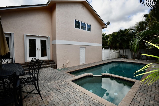 view of swimming pool featuring an in ground hot tub, a patio, and french doors