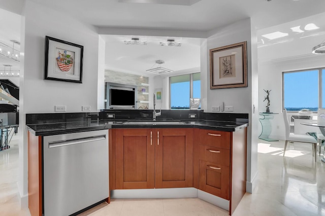 kitchen featuring stainless steel dishwasher, dark stone counters, and sink