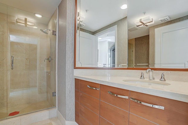 bathroom with vanity and walk in shower