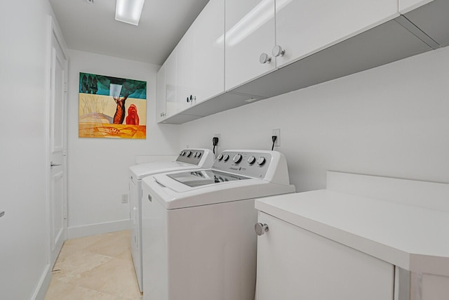 laundry area with cabinets and washing machine and dryer