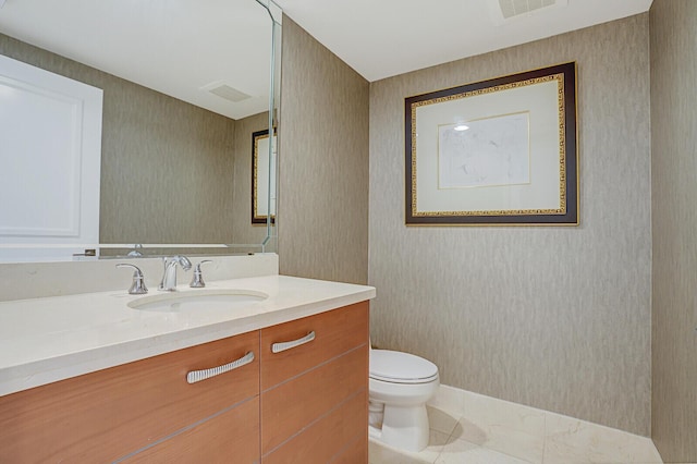 bathroom with vanity, tile patterned floors, and toilet