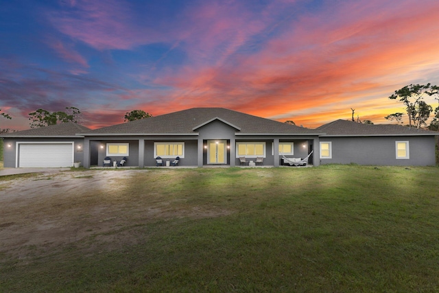 view of front of house featuring a lawn and a garage