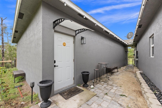 doorway to property with a patio area