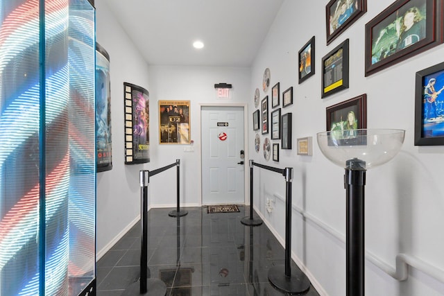 hall with dark tile patterned floors