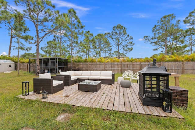 deck featuring outdoor lounge area and a yard