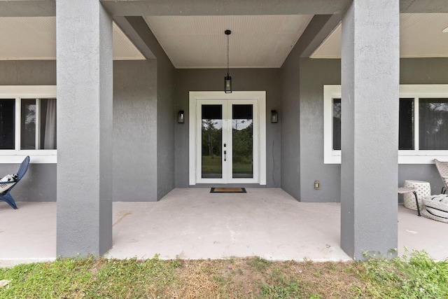 view of exterior entry featuring french doors