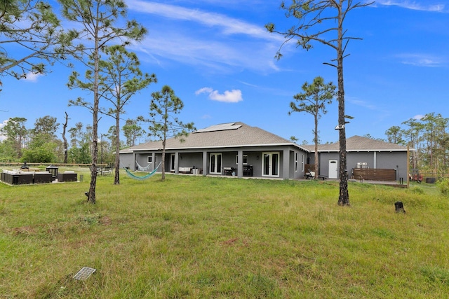 rear view of house featuring a lawn