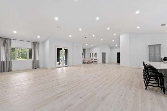 living room featuring lofted ceiling and light wood-type flooring