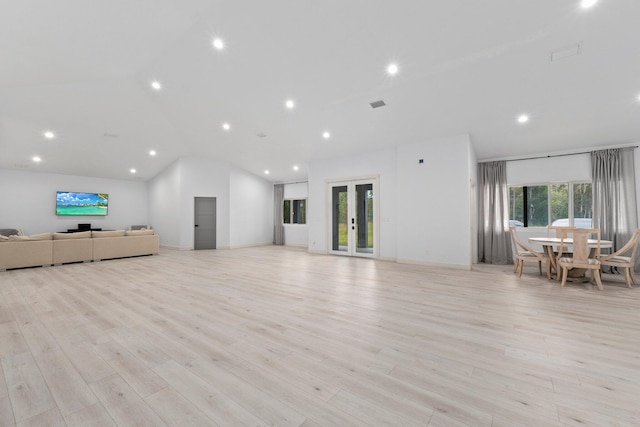 unfurnished living room featuring light hardwood / wood-style floors and vaulted ceiling