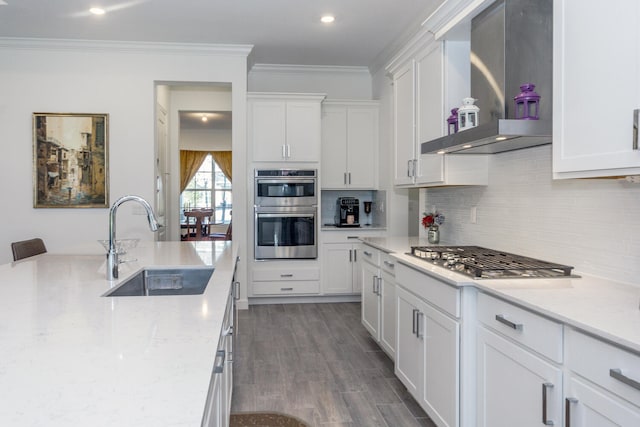 kitchen featuring white cabinets, wall chimney exhaust hood, and sink