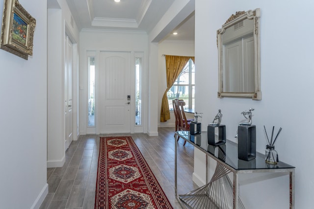 foyer featuring dark hardwood / wood-style floors and ornamental molding