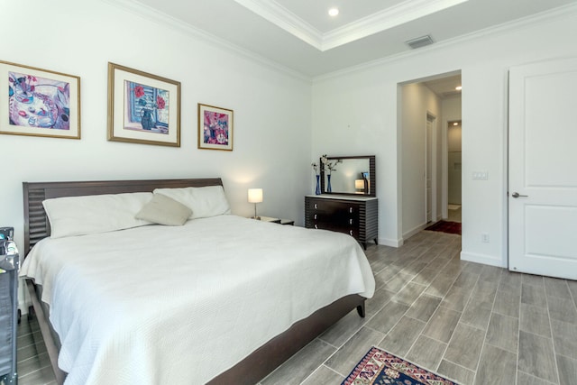 bedroom with hardwood / wood-style floors and crown molding