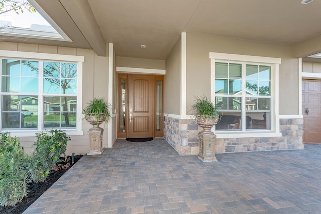 view of exterior entry with covered porch