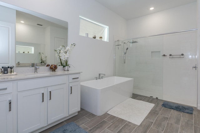 bathroom featuring vanity and shower with separate bathtub