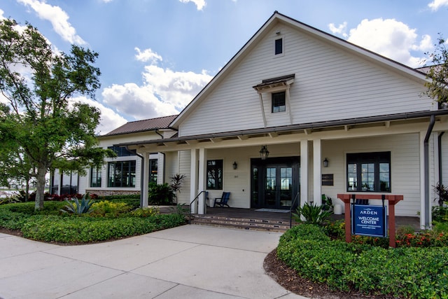 view of front facade with a porch and french doors