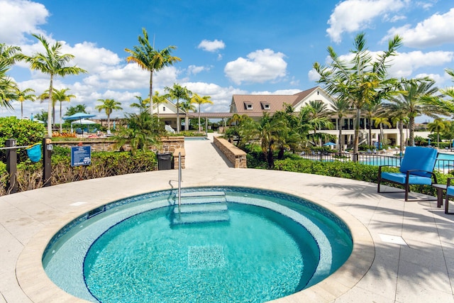 view of swimming pool featuring a community hot tub