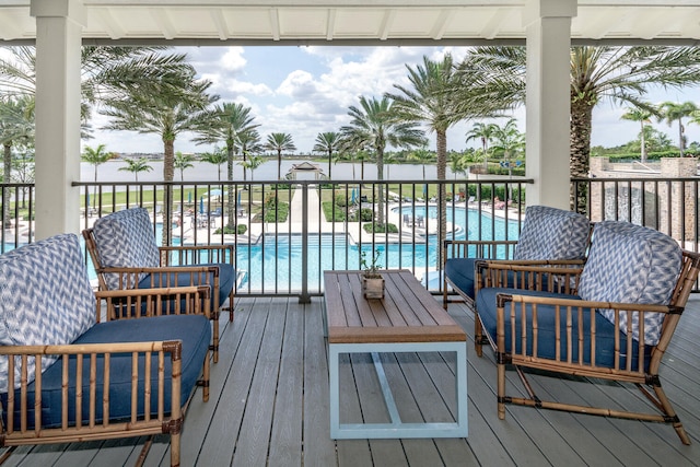 wooden terrace with a fenced in pool