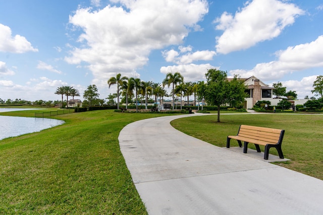 view of property's community featuring a water view and a yard