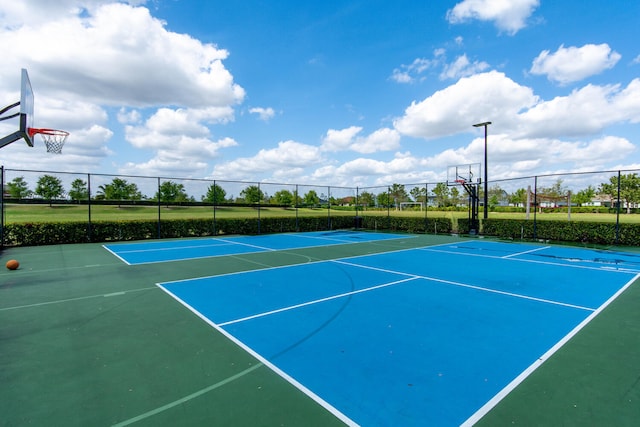 view of tennis court featuring basketball hoop