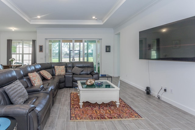 living room featuring a wealth of natural light, light hardwood / wood-style floors, and ornamental molding