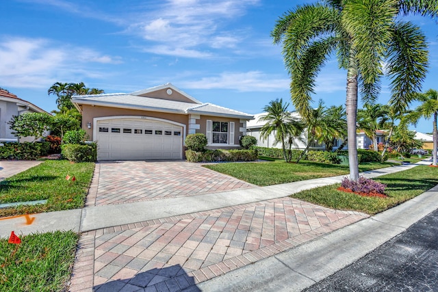 ranch-style home with a garage and a front yard