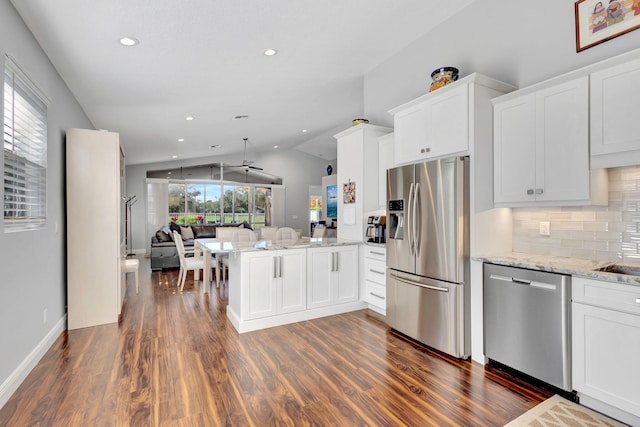 kitchen featuring white cabinets, appliances with stainless steel finishes, ceiling fan, and lofted ceiling