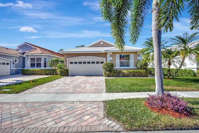 single story home with a garage and a front yard