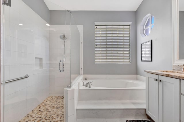 bathroom featuring vanity and shower with separate bathtub