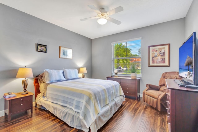 bedroom with ceiling fan and dark wood-type flooring